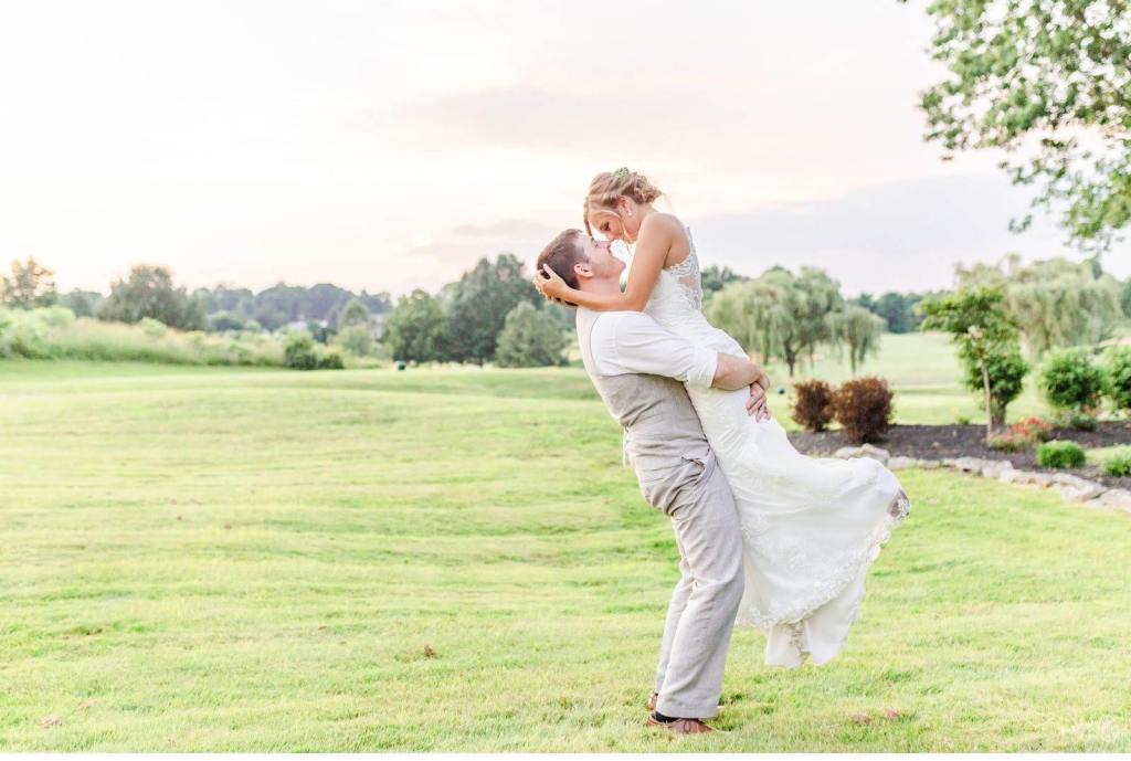 Kaylee and Nate embracing on golf course fairway